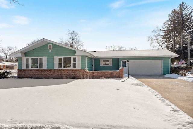 ranch-style home featuring concrete driveway, brick siding, and a garage