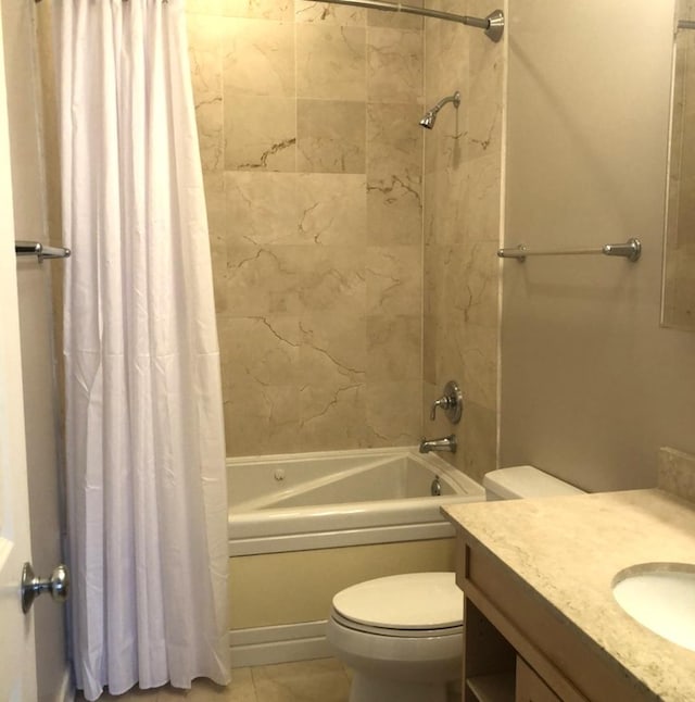 full bath featuring tile patterned floors, shower / tub combo with curtain, vanity, and toilet