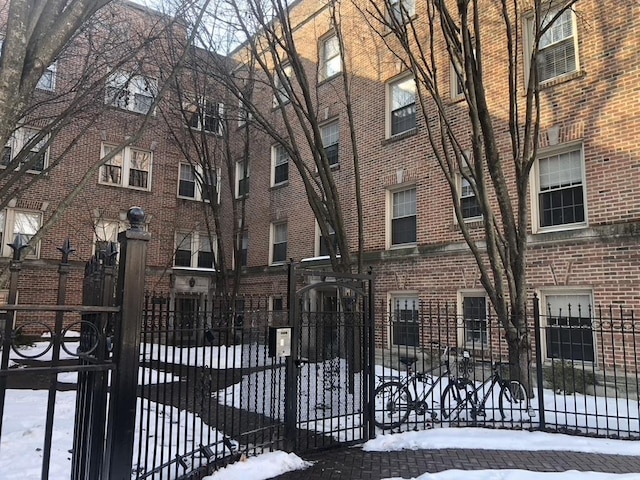 snow covered gate featuring fence