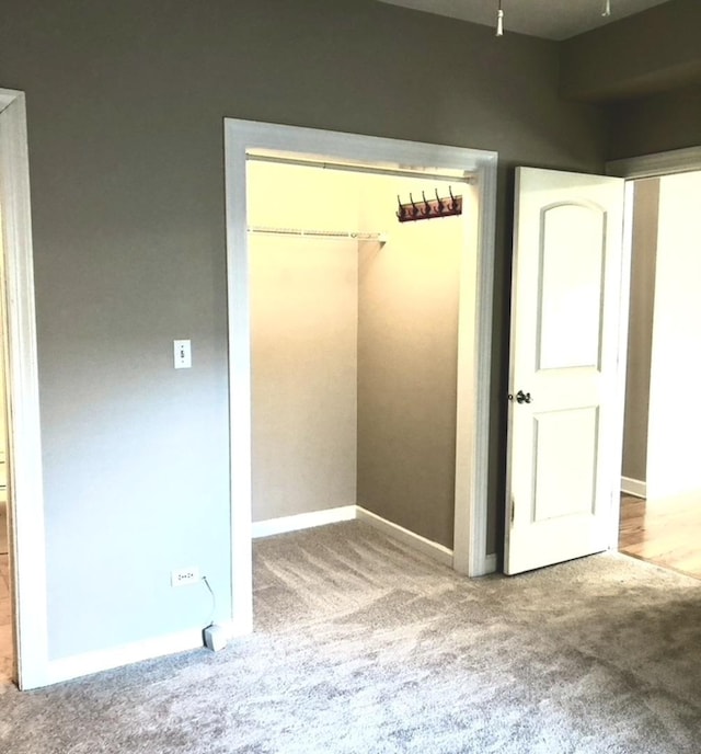 unfurnished bedroom with a closet and carpet flooring