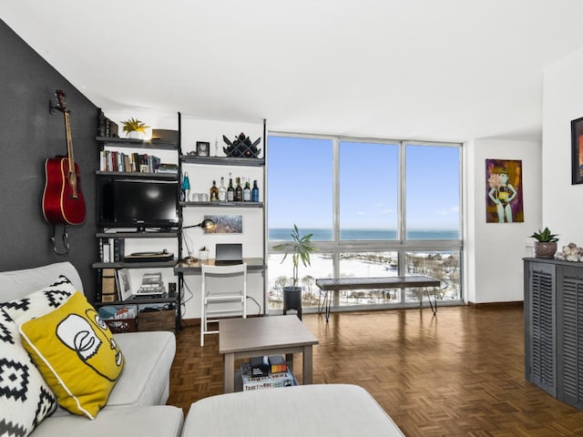 living room featuring floor to ceiling windows and dark parquet floors