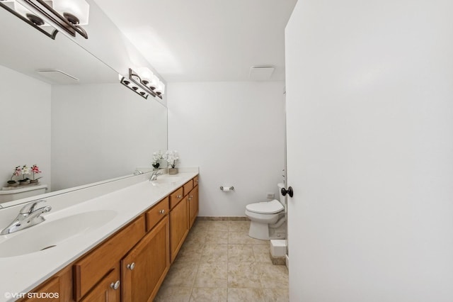 bathroom with tile patterned floors, vanity, and toilet