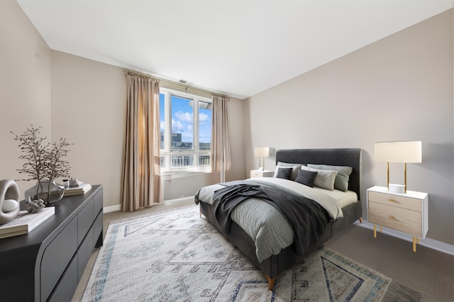 bedroom with light colored carpet and lofted ceiling