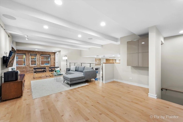 living room featuring light hardwood / wood-style floors and beamed ceiling