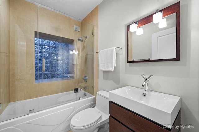 full bathroom featuring enclosed tub / shower combo, vanity, and toilet