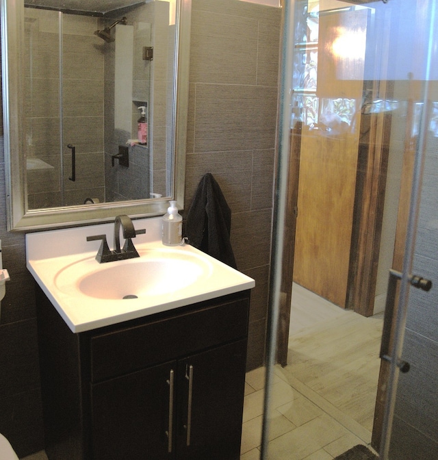 bathroom featuring tile walls and vanity