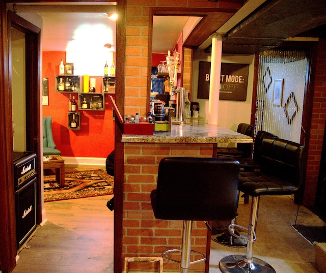 bar with wood-type flooring