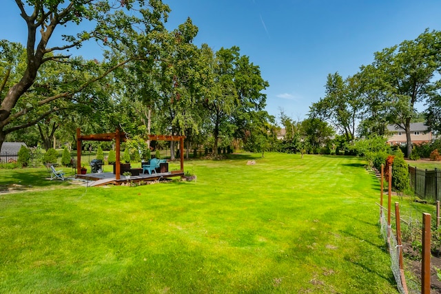 view of yard featuring a wooden deck and a pergola