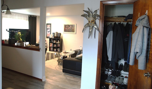 hallway with hardwood / wood-style flooring