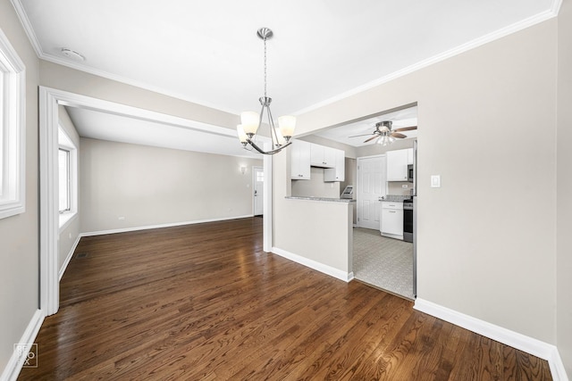 unfurnished dining area featuring crown molding, ceiling fan with notable chandelier, and dark hardwood / wood-style flooring