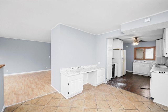 kitchen with light tile patterned floors, white cabinetry, a ceiling fan, light countertops, and white fridge with ice dispenser