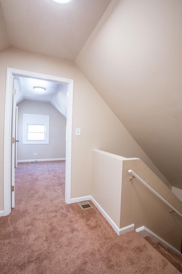 bonus room with lofted ceiling, baseboards, visible vents, and carpet flooring