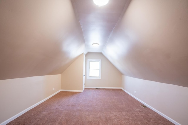 bonus room with carpet, visible vents, lofted ceiling, and baseboards