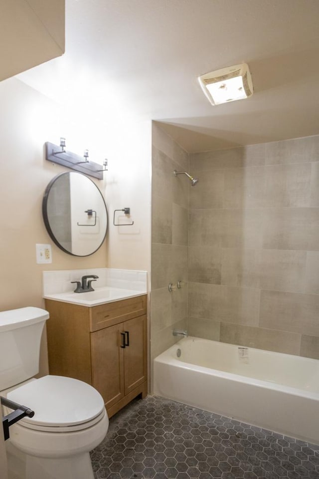 bathroom featuring washtub / shower combination, tile patterned flooring, vanity, and toilet