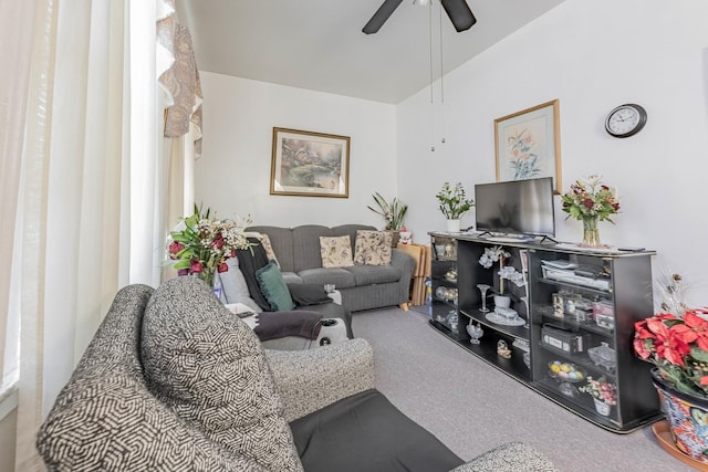 carpeted living room with a ceiling fan