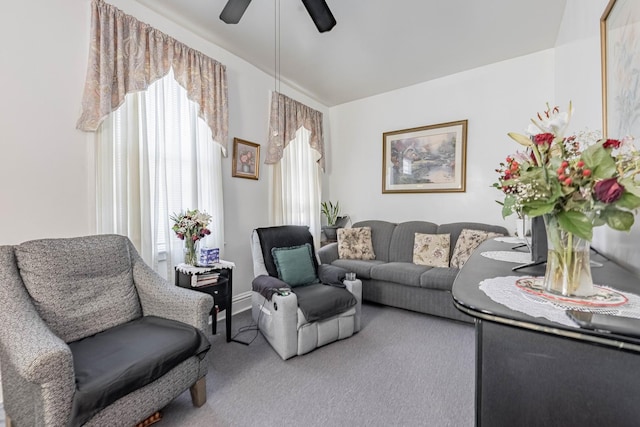 living area with carpet flooring and a ceiling fan