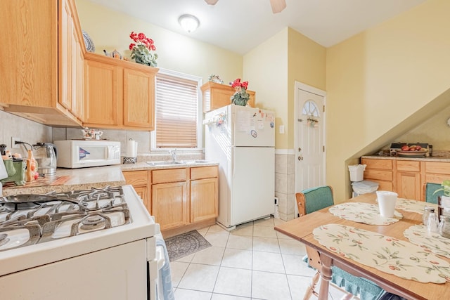 kitchen featuring white appliances, ceiling fan, light tile patterned floors, and light brown cabinetry