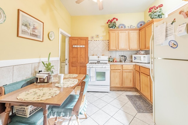 kitchen featuring white appliances, light tile patterned floors, a ceiling fan, light countertops, and light brown cabinetry