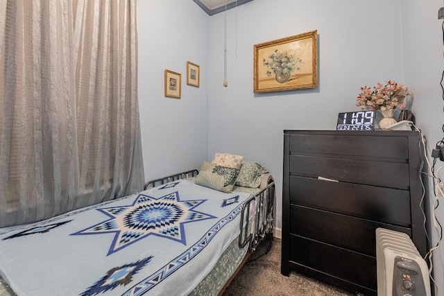 carpeted bedroom with attic access and radiator