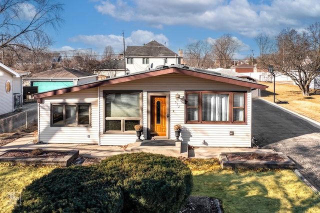 view of front of property featuring a front lawn and a patio