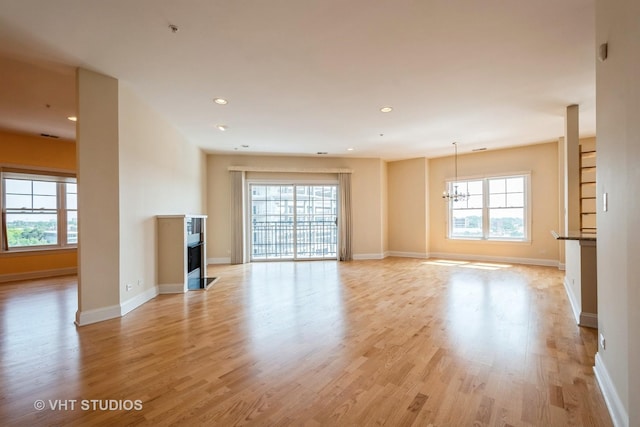 4953 Oakton St Unit 605, Skokie, IL 60077 - unfurnished living room with a fireplace with flush hearth, a chandelier, light wood-style floors, and recessed lighting