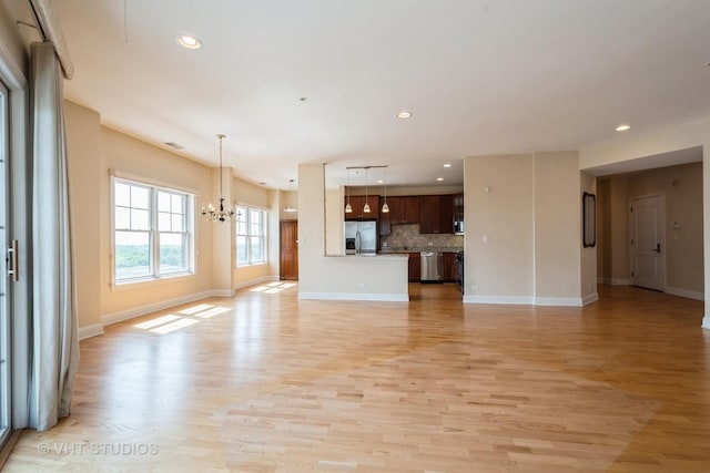 4953 Oakton St Unit 605, Skokie, IL 60077 - unfurnished living room featuring a chandelier, light wood finished floors, and recessed lighting