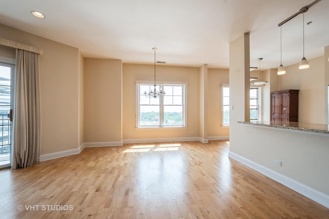 4953 Oakton St Unit 605, Skokie, IL 60077 - unfurnished living room with a chandelier, light wood-style floors, and recessed lighting