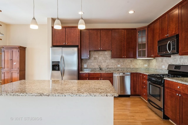 4953 Oakton St Unit 605, Skokie, IL 60077 - kitchen with appliances with stainless steel finishes, light wood finished floors, tasteful backsplash, light stone countertops, and recessed lighting