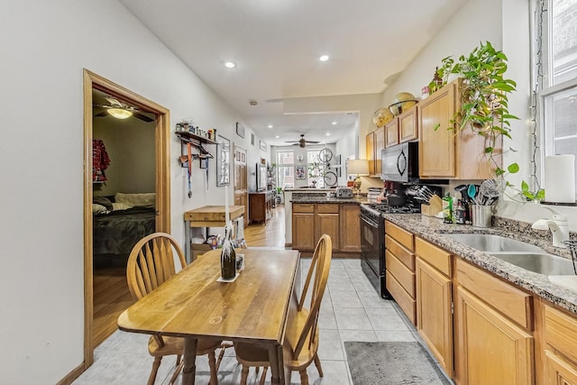 816 N Hermitage Ave, Chicago, IL 60622 - kitchen with black appliances, a peninsula, a sink, a ceiling fan, and light tile patterned flooring