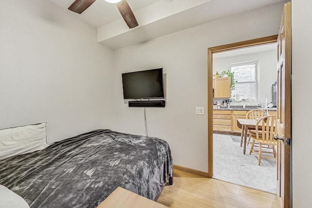 816 N Hermitage Ave, Chicago, IL 60622 - bedroom with light wood-style floors, baseboards, ceiling fan, and beam ceiling