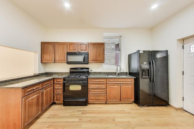 816 N Hermitage Ave, Chicago, IL 60622 - kitchen featuring black appliances, a sink, light wood finished floors, and brown cabinetry