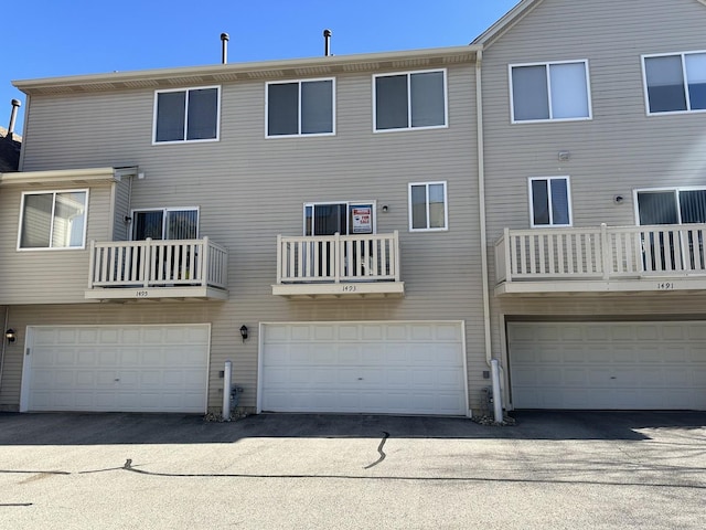 rear view of property with an attached garage