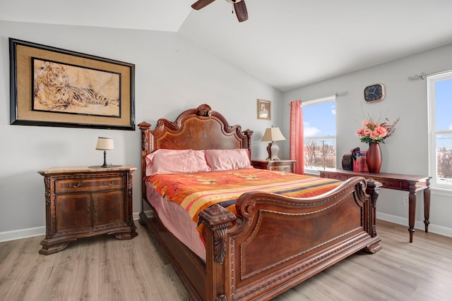 bedroom with ceiling fan, lofted ceiling, and light hardwood / wood-style floors