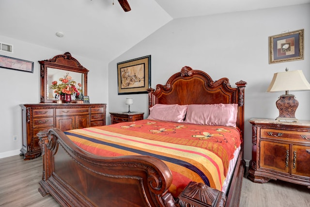 bedroom with vaulted ceiling, ceiling fan, and light hardwood / wood-style floors