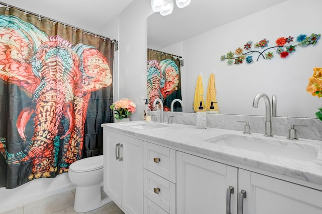 bathroom featuring tile patterned flooring, vanity, and toilet