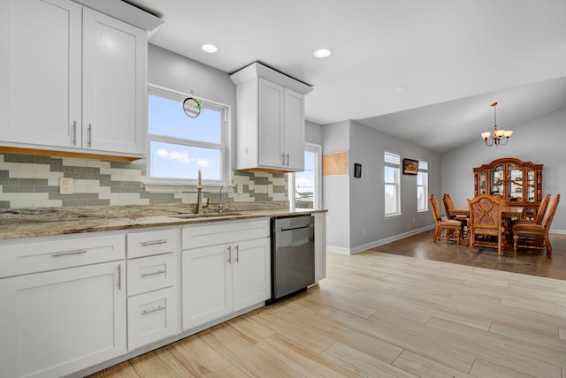 kitchen featuring tasteful backsplash, dishwasher, sink, white cabinets, and light wood-type flooring