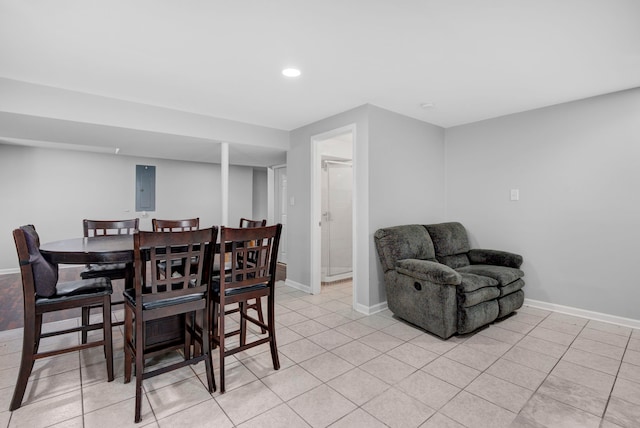 dining area featuring electric panel and light tile patterned floors