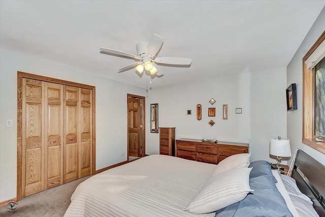 bedroom with ceiling fan, light colored carpet, and a closet