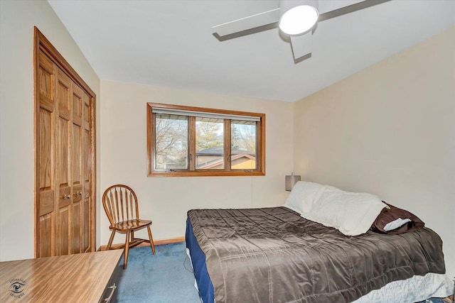 carpeted bedroom featuring ceiling fan and a closet