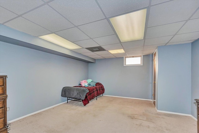 carpeted bedroom featuring a paneled ceiling