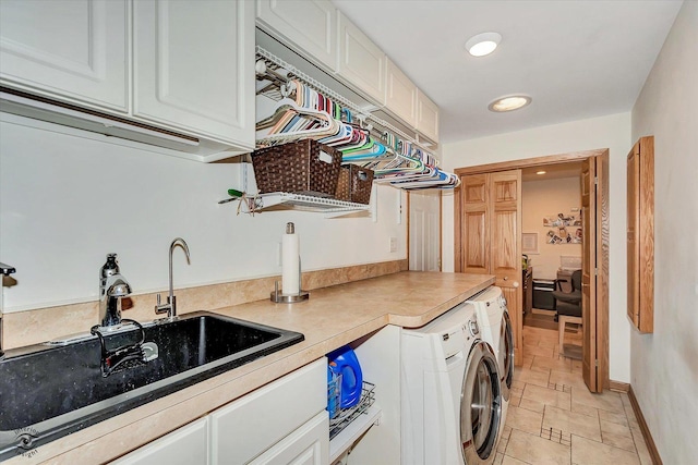 laundry area featuring cabinets, sink, and washing machine and dryer