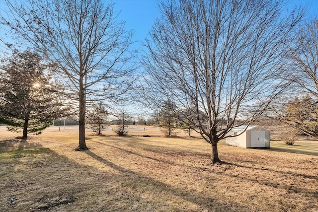 view of yard featuring a storage unit and a rural view