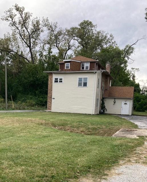 view of outbuilding with a yard