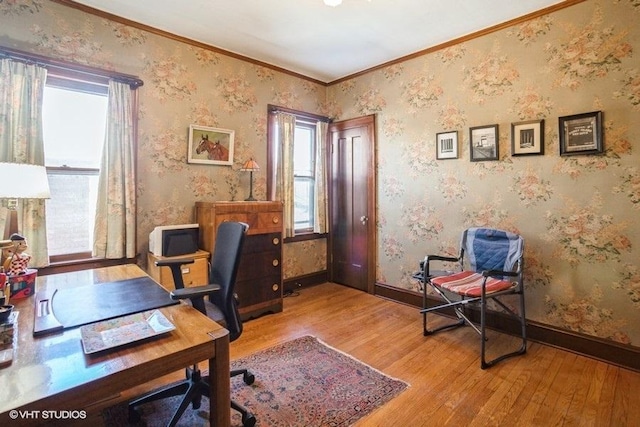 office area featuring baseboards, light wood-type flooring, and wallpapered walls