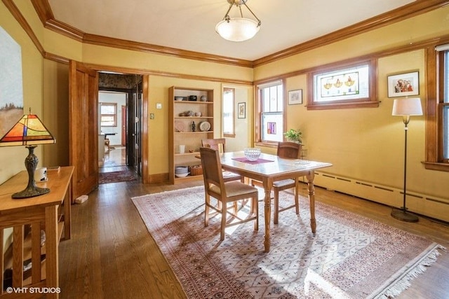 dining space featuring a wealth of natural light, ornamental molding, and hardwood / wood-style floors