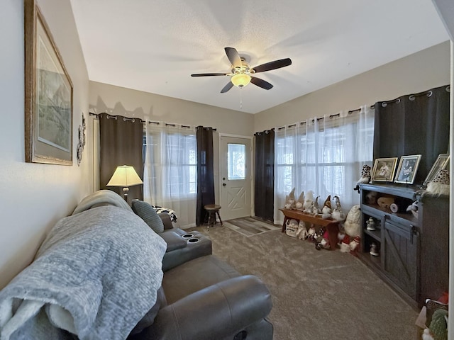 carpeted living area featuring ceiling fan