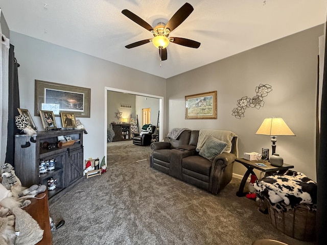 carpeted living area featuring a ceiling fan