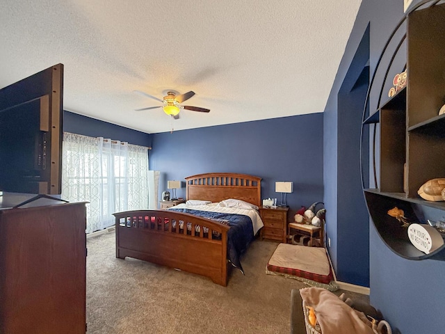 carpeted bedroom featuring a ceiling fan and a textured ceiling