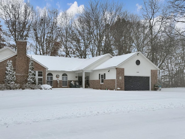 view of front of home featuring a garage and brick siding