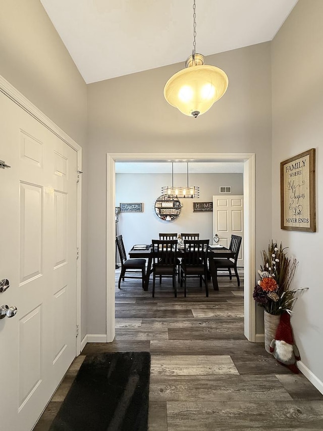 dining space featuring high vaulted ceiling, baseboards, visible vents, and dark wood-style flooring